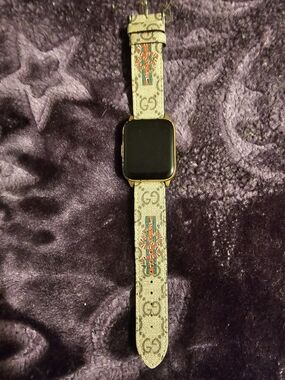Gucci Gold-Tone Smartwatch with Beige Monogram Fabric Band